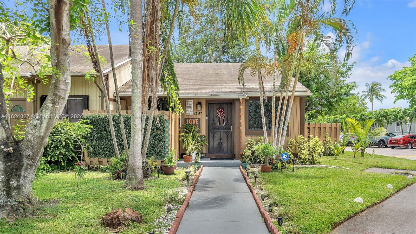 a front view of a house with garden