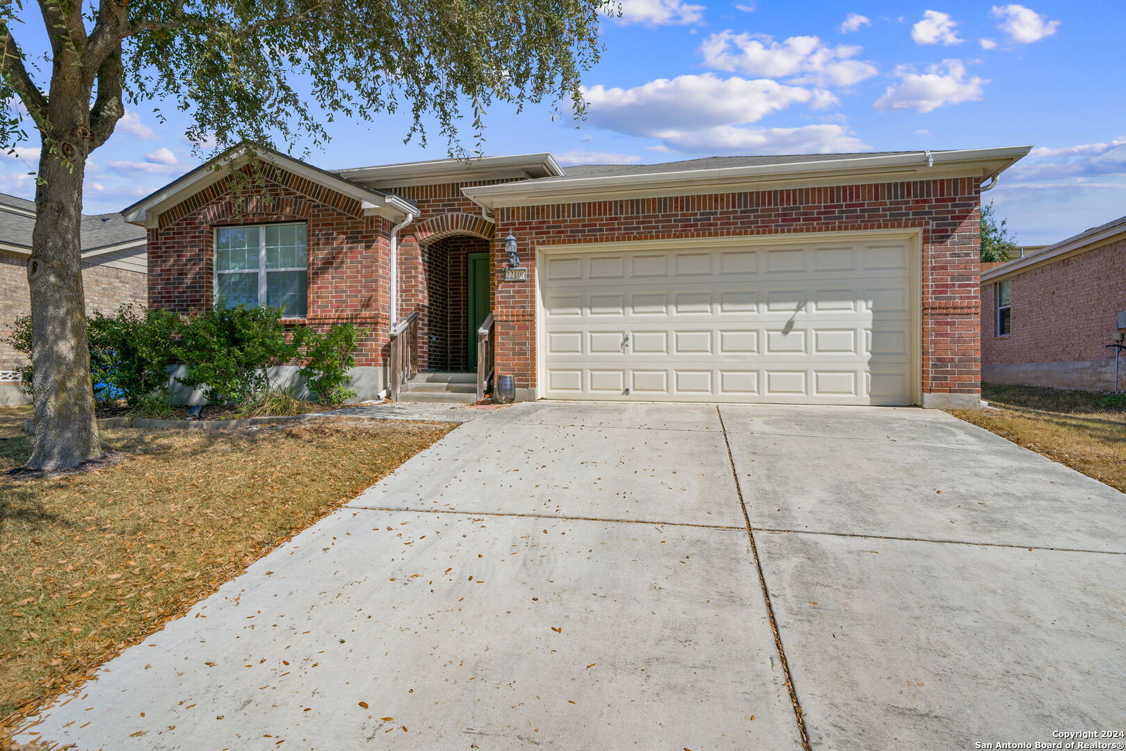 a front view of a house with a yard and garage