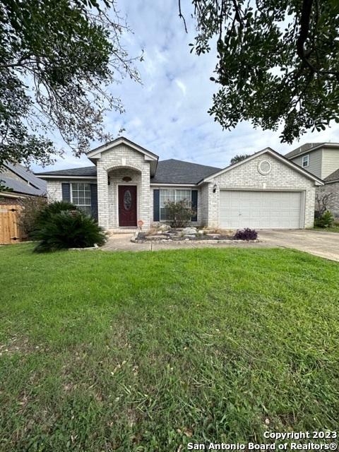 a front view of a house with a yard and trees