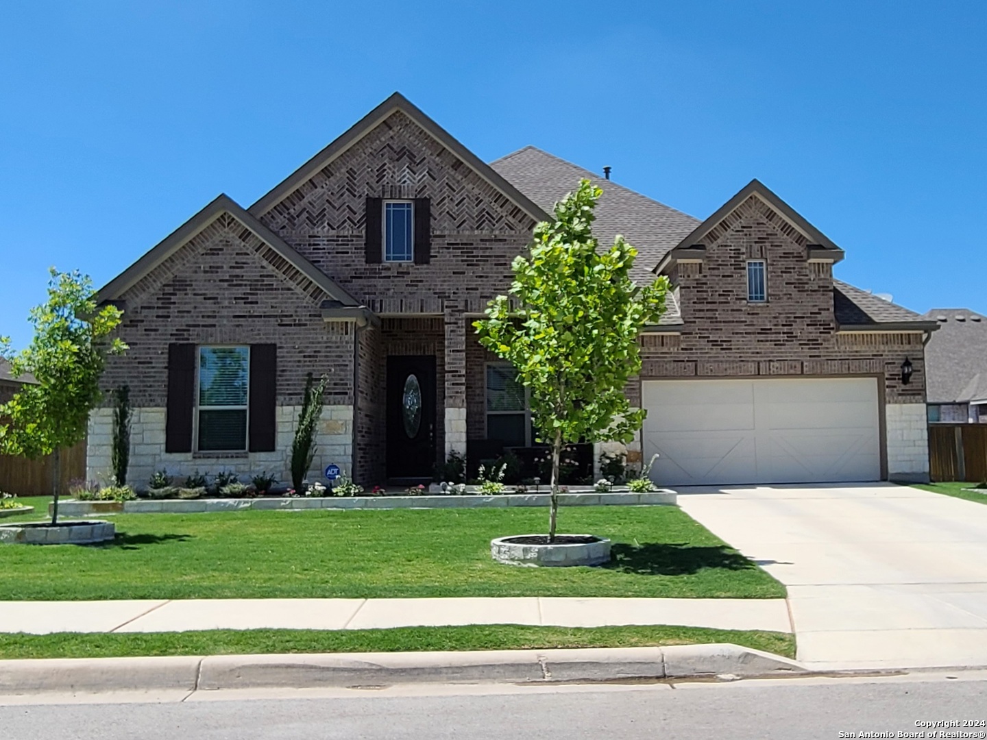 a front view of a house with a yard and garage