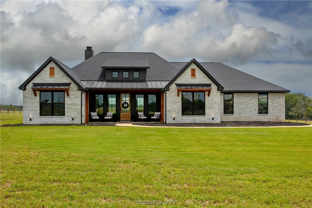 a front view of a house with a garden and porch