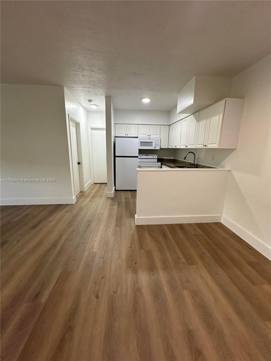 a view of a kitchen with wooden floor