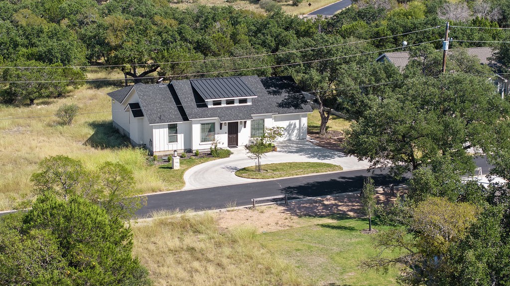 an aerial view of a house with swimming pool and garden