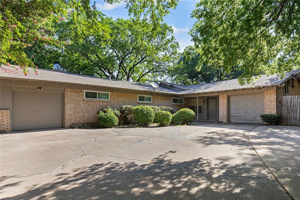 a front view of a house with a yard and a garage