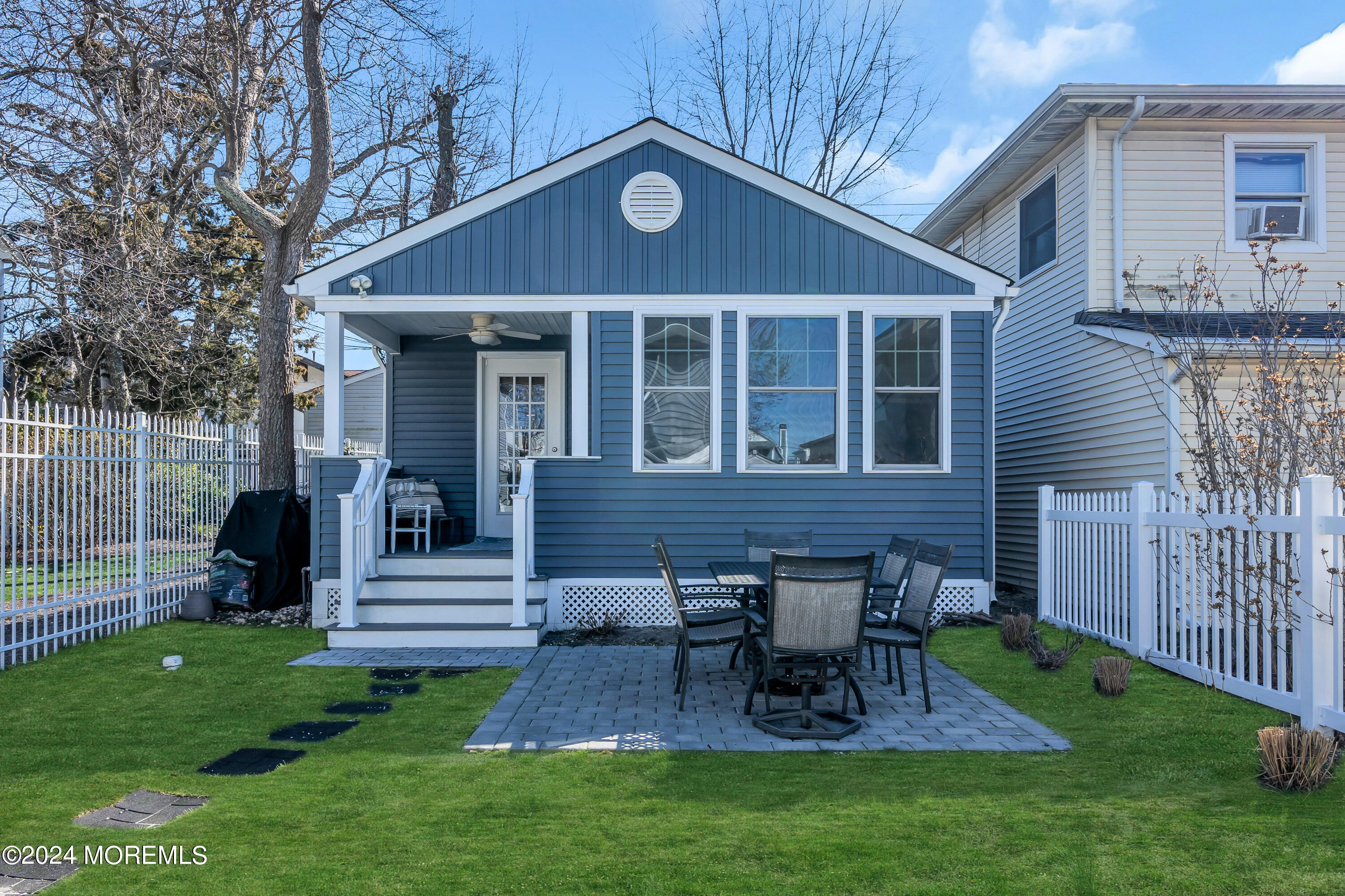 a view of a house with a yard and furniture