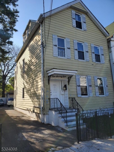 a view of a house with wooden deck