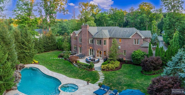 a view of a house with a big yard plants and large trees