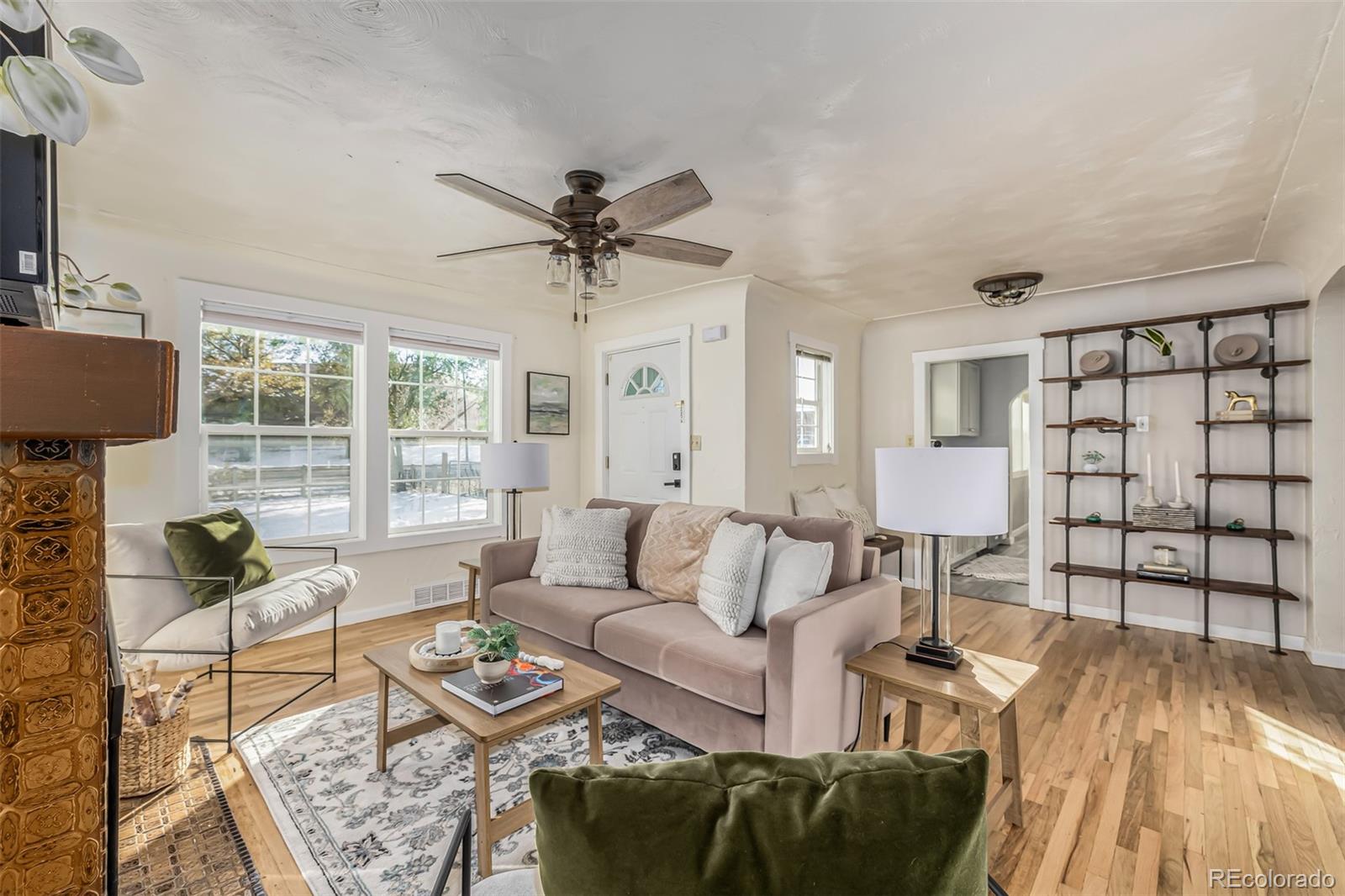 a living room with furniture and wooden floor