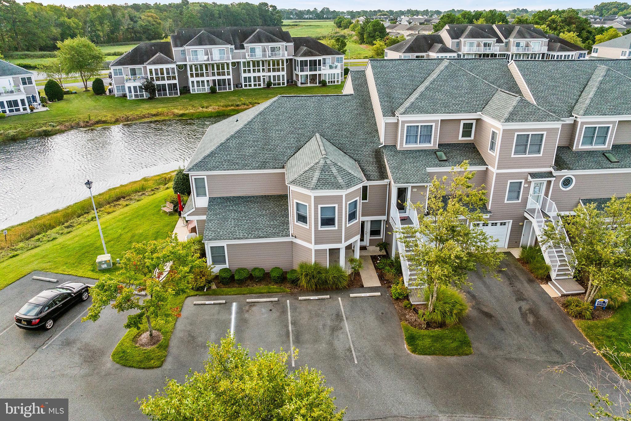 an aerial view of residential houses with outdoor space and swimming pool