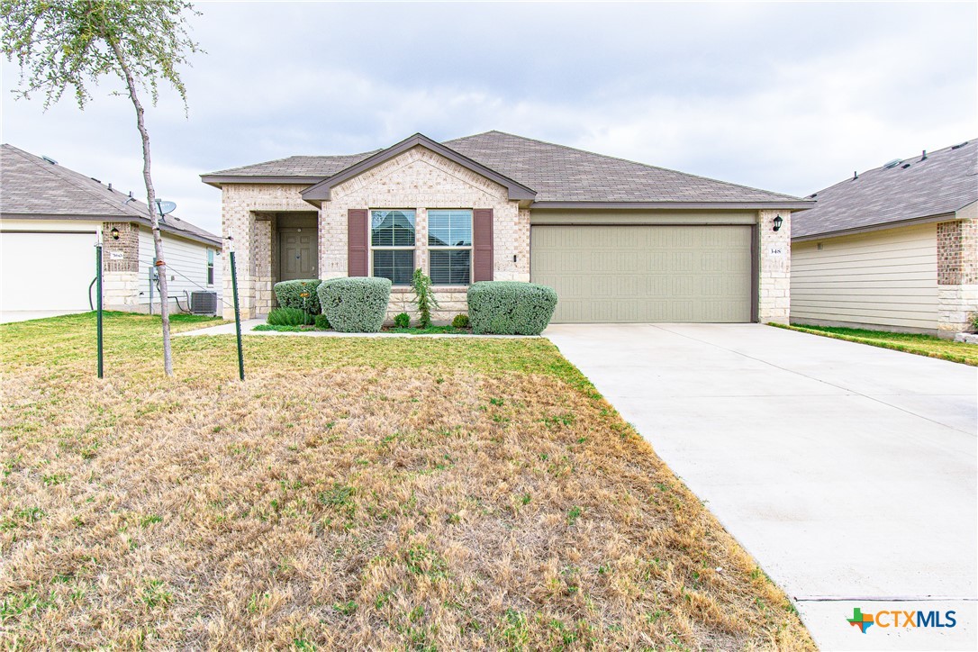 a front view of a house with a yard and garage