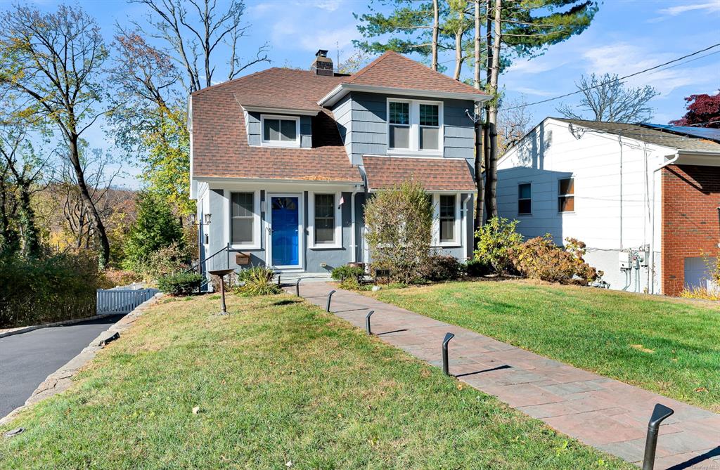 a front view of a house with a yard table and chairs