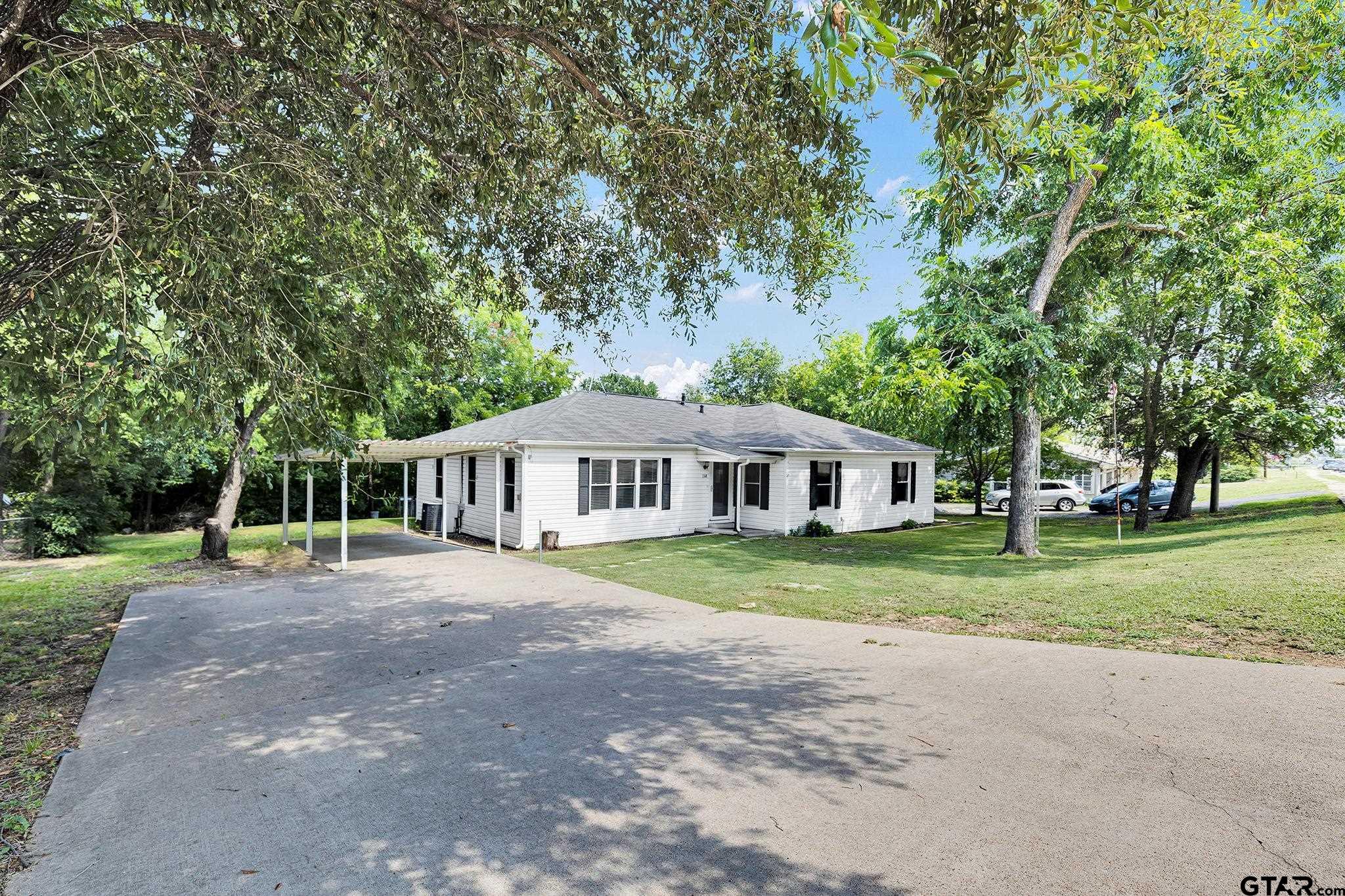 a big house with trees in front of it