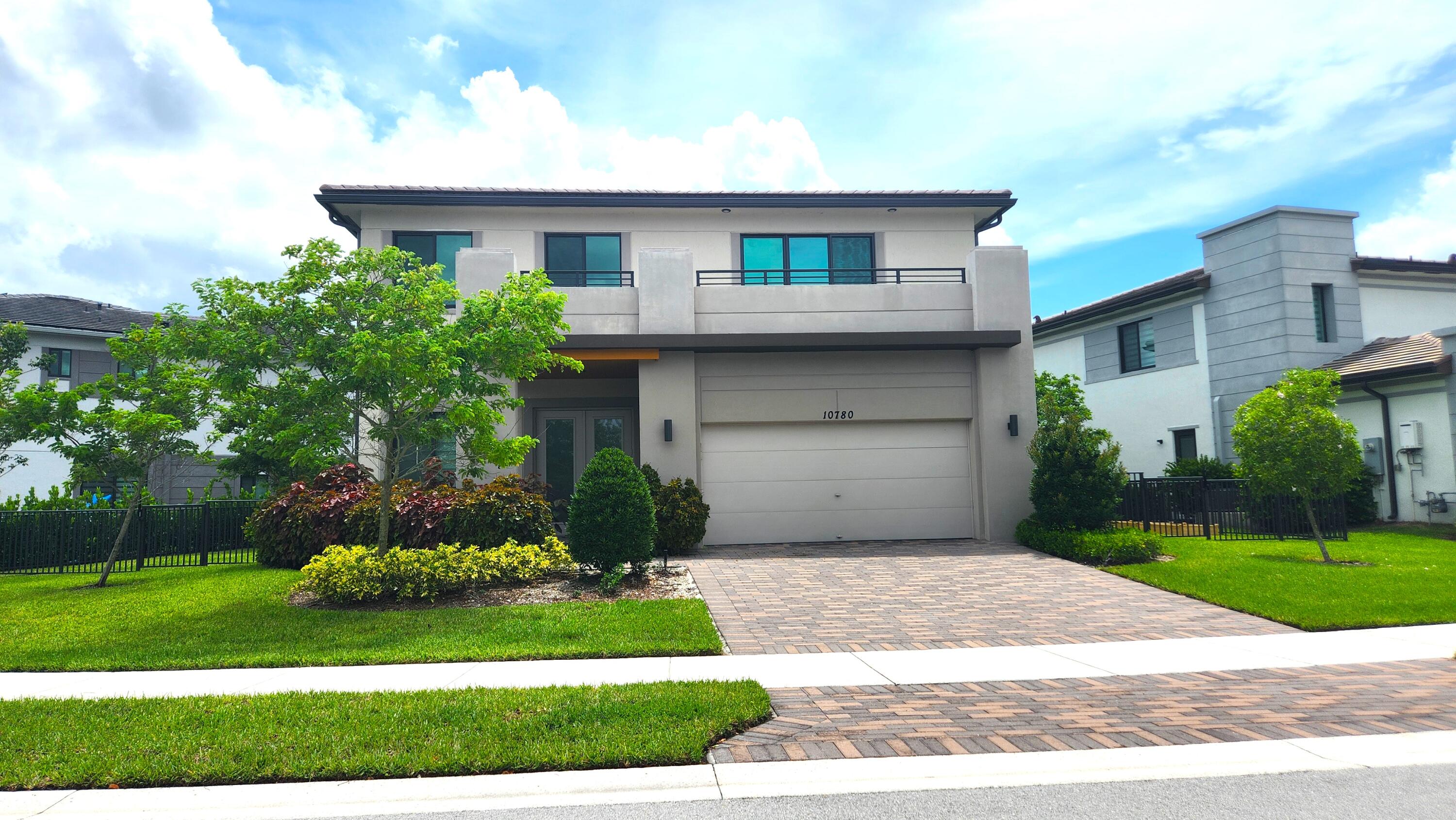 a front view of a house with a yard and a garage