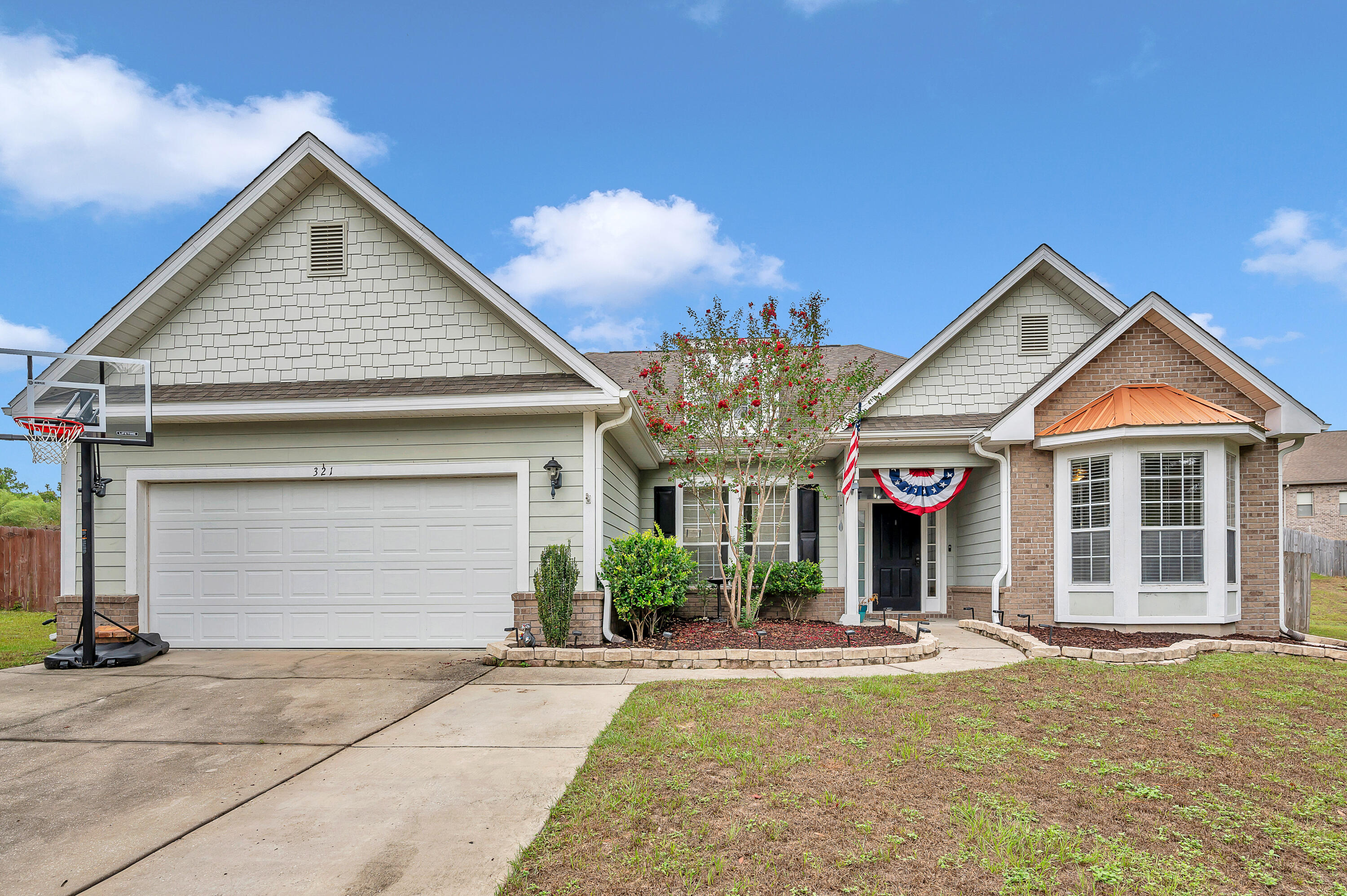 a front view of a house with yard and garage