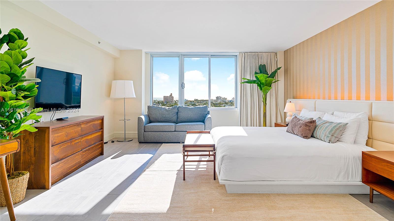 a bedroom with furniture and a flat screen tv