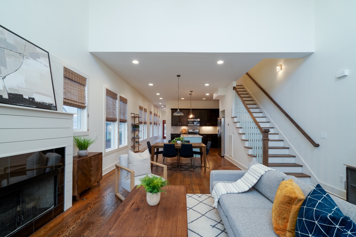 a living room with furniture and wooden floor