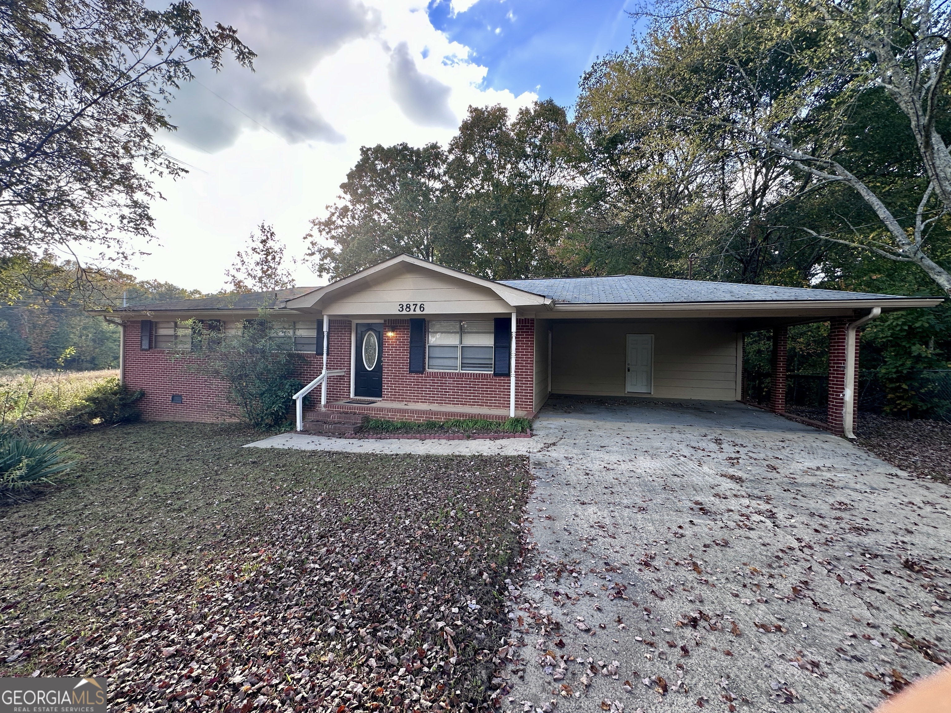 a view of a house with a yard and a tree