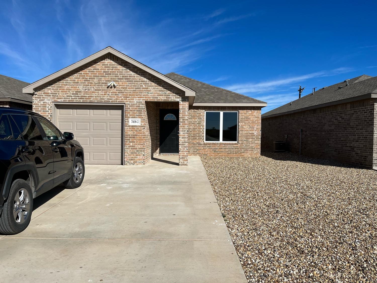 a front view of a house with parking space