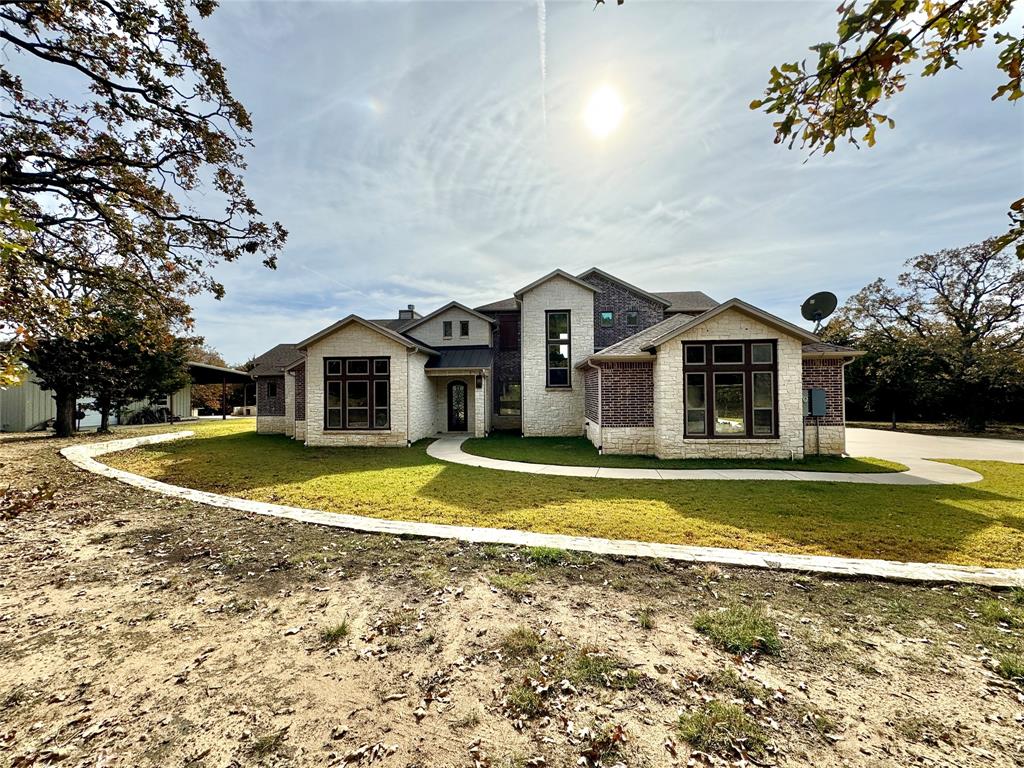 a front view of house with outdoor space and swimming pool