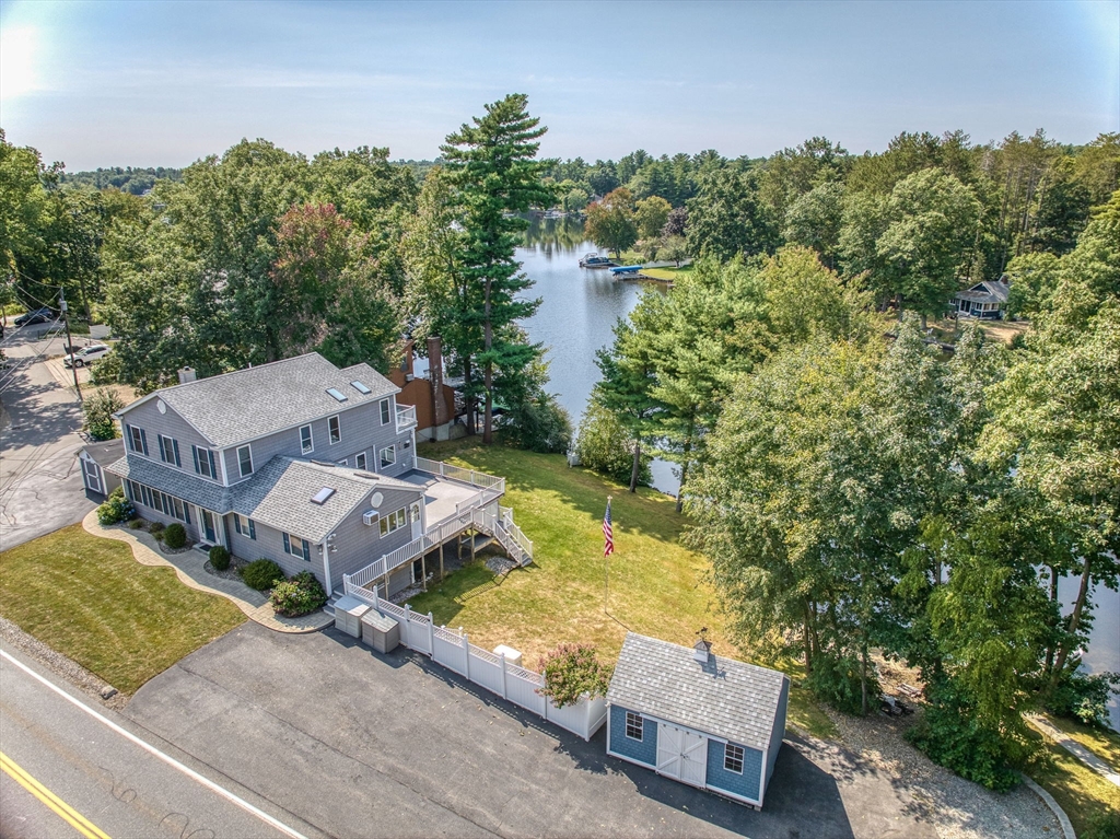 an aerial view of a house with garden space and street view