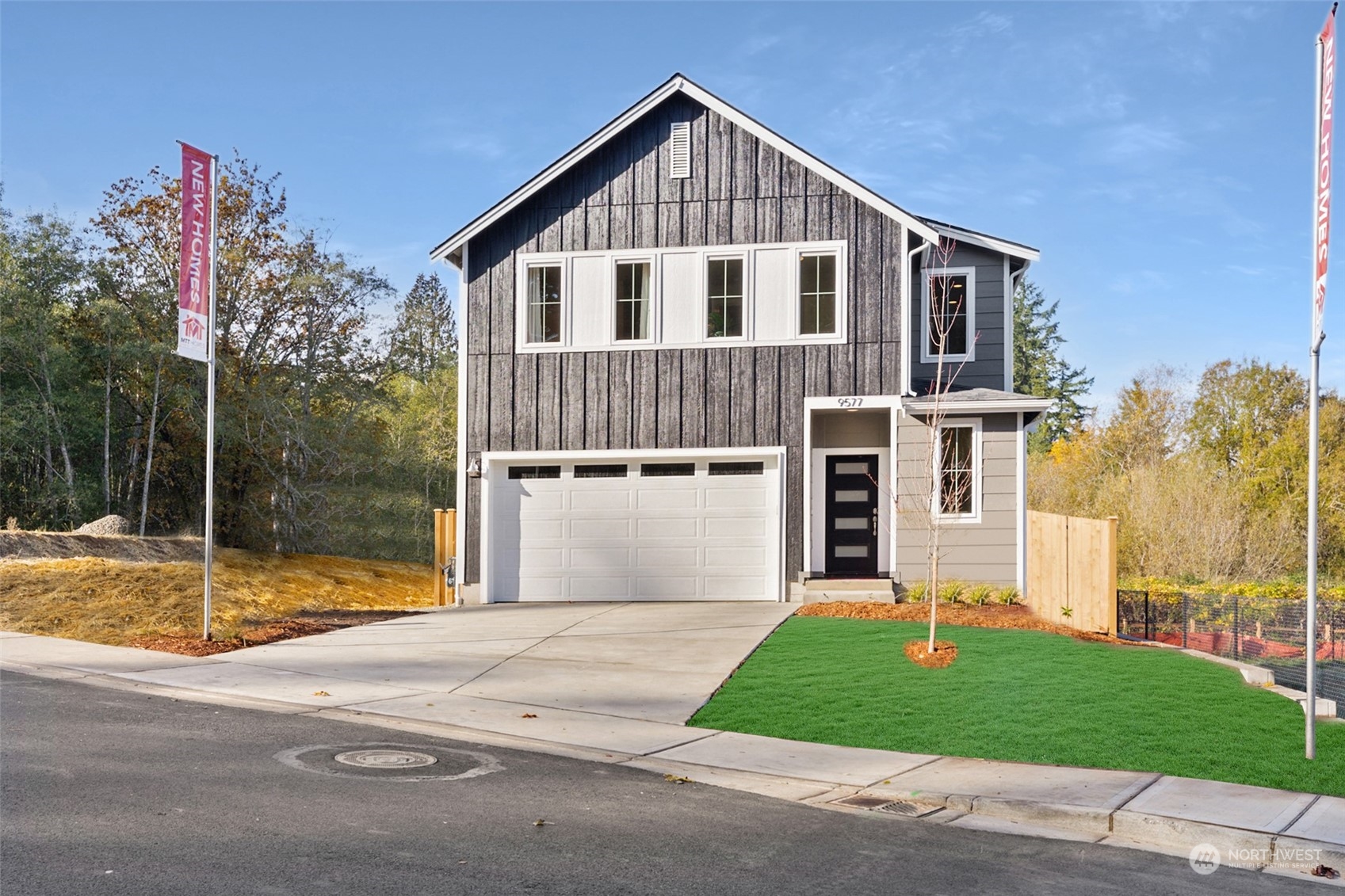 a front view of a house with a yard and garage