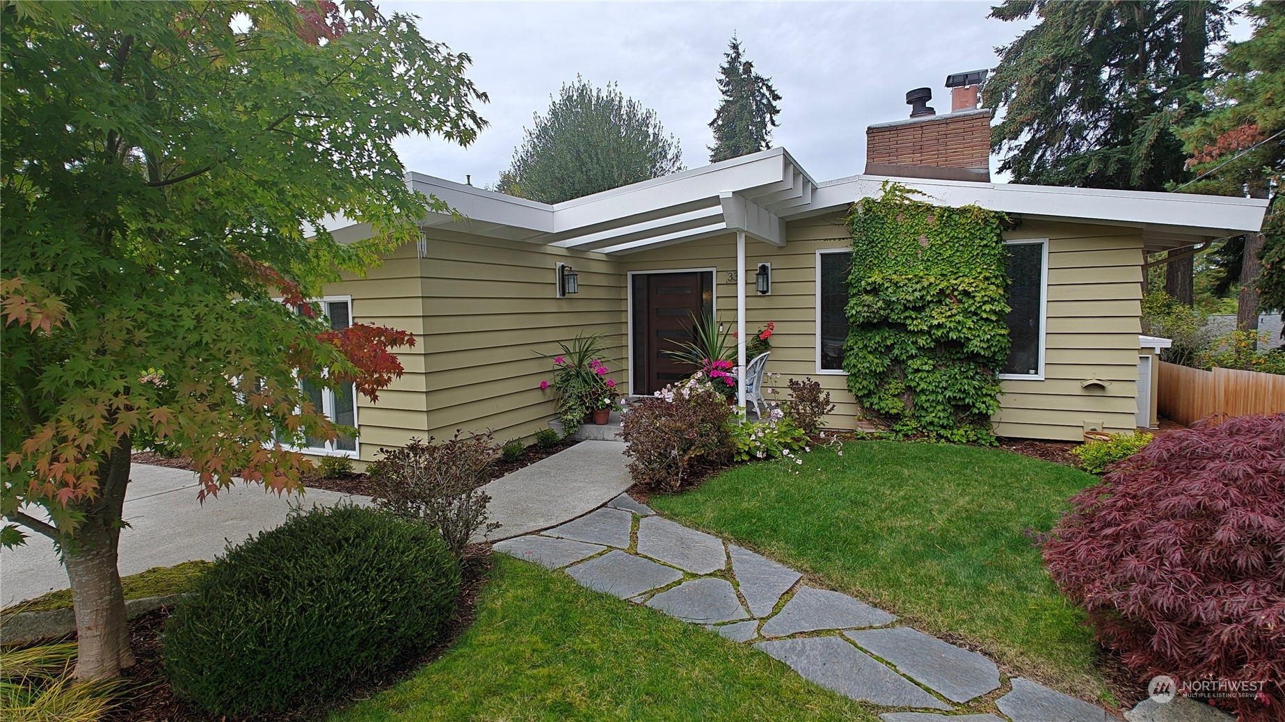 a front view of house with a garden