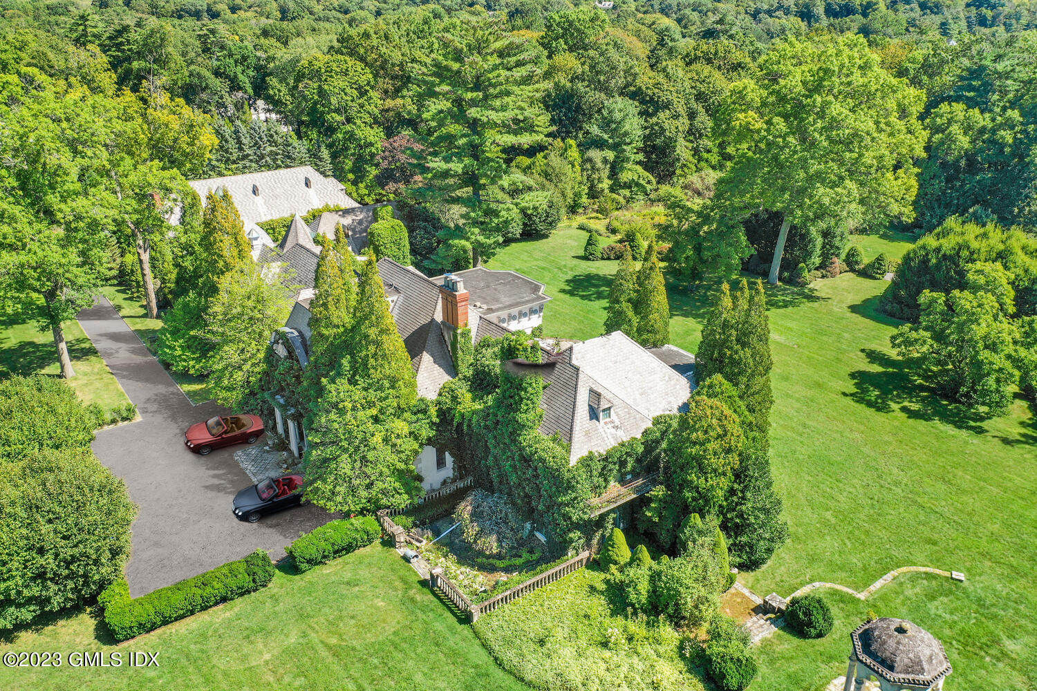 an aerial view of a house with a yard basket ball court and outdoor seating