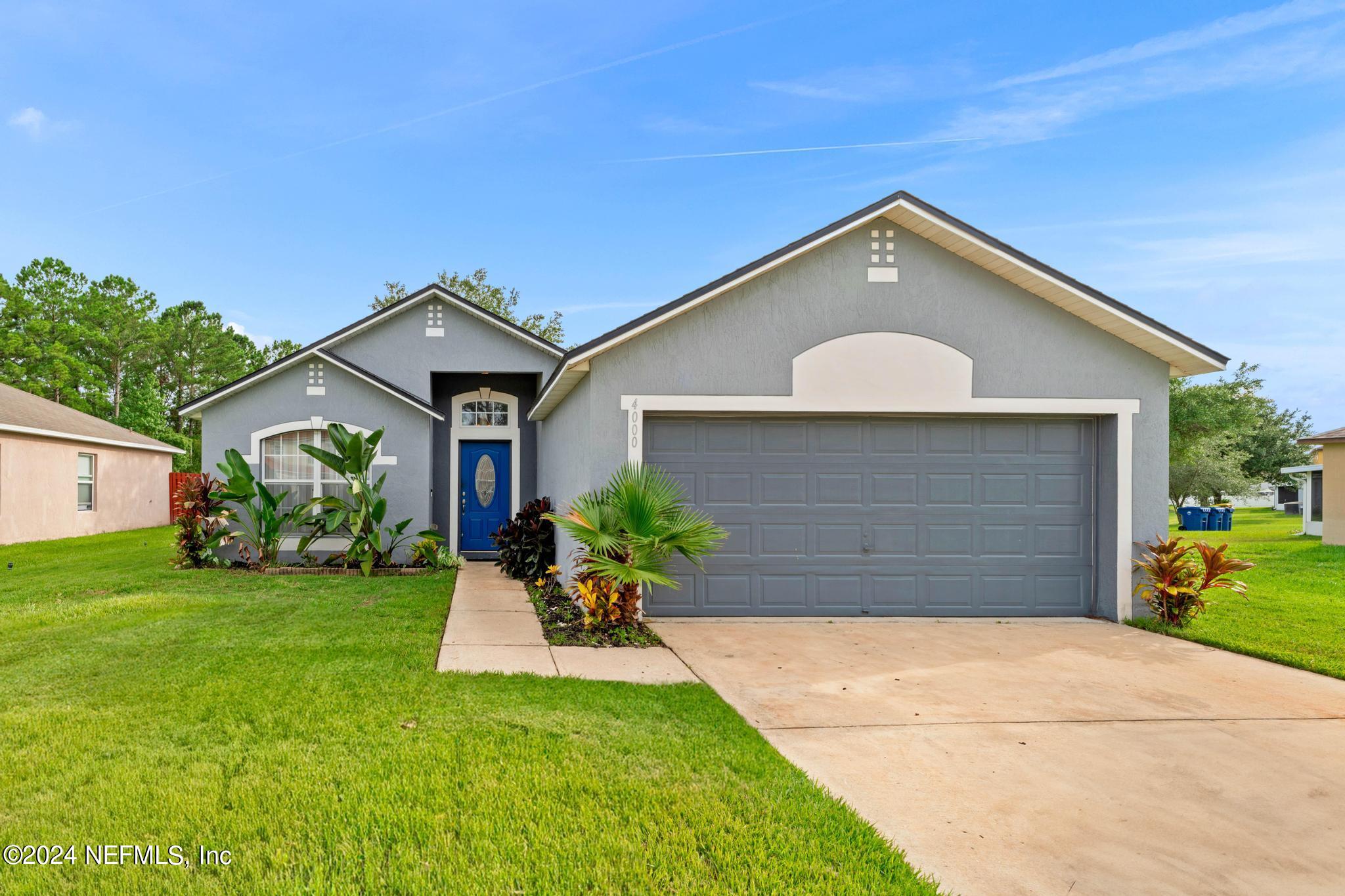 a front view of house with yard and green space