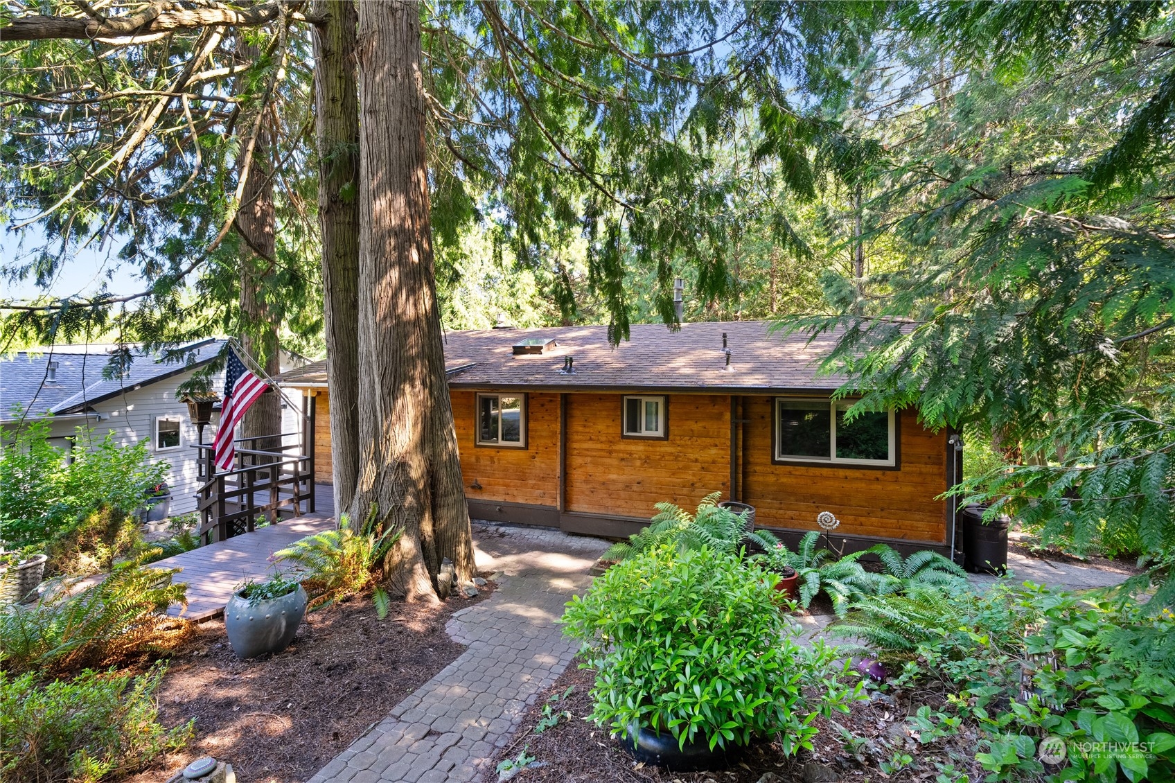 a front view of a house with a tree