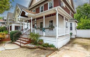 a view of a house with wooden fence and a porch