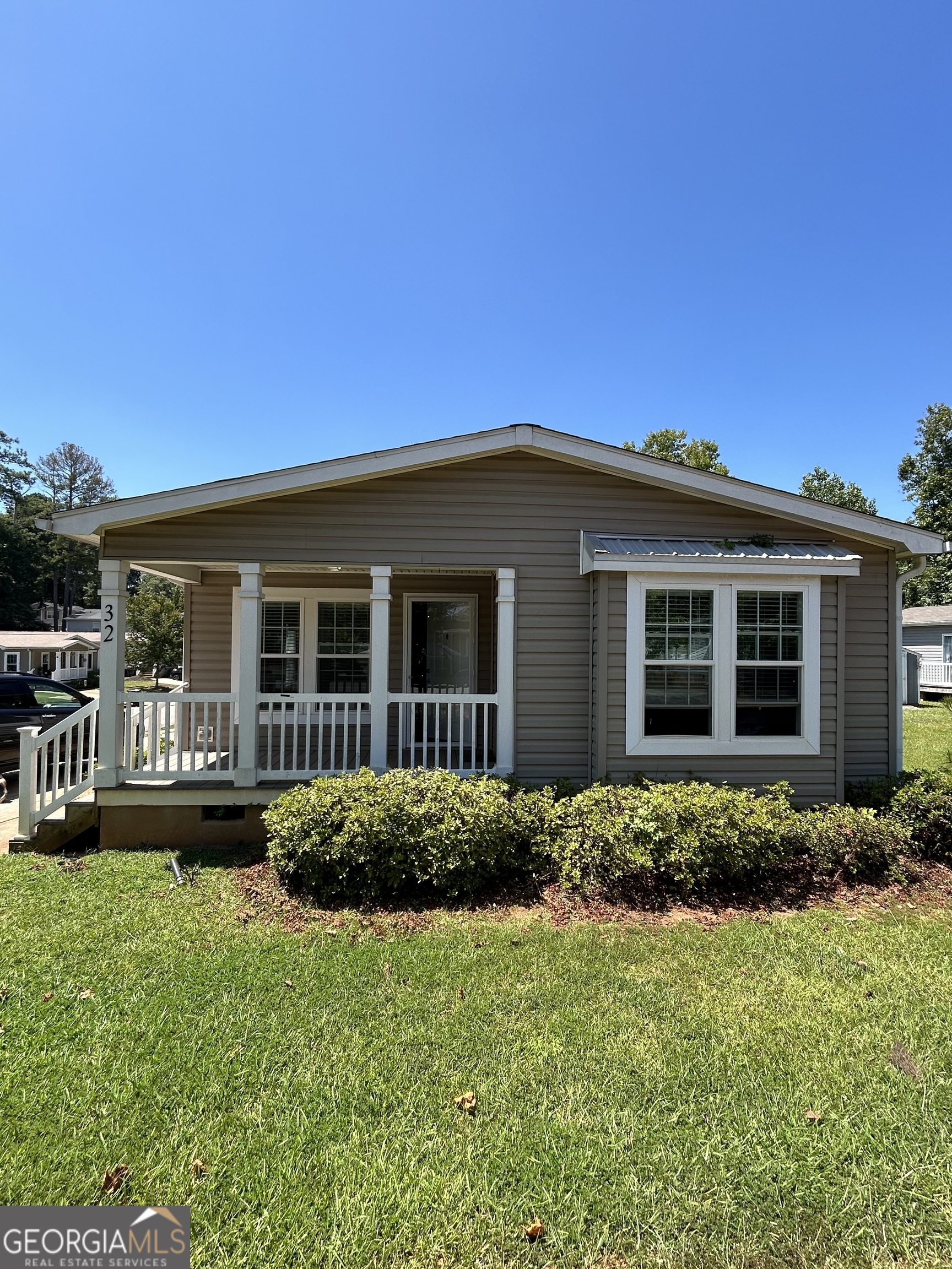 front view of a house with a garden