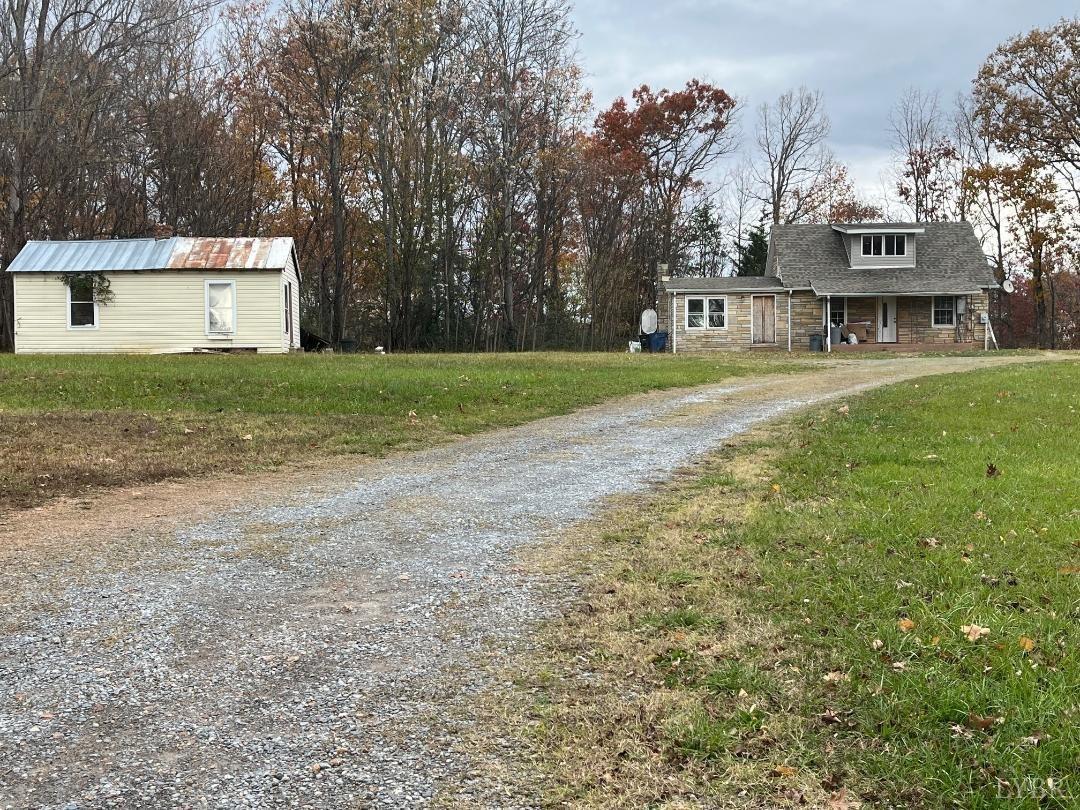 a view of a house with a yard and garage