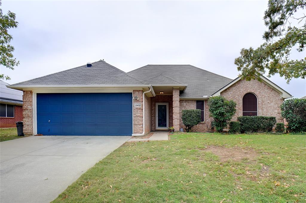 a view of a house with a yard and garage