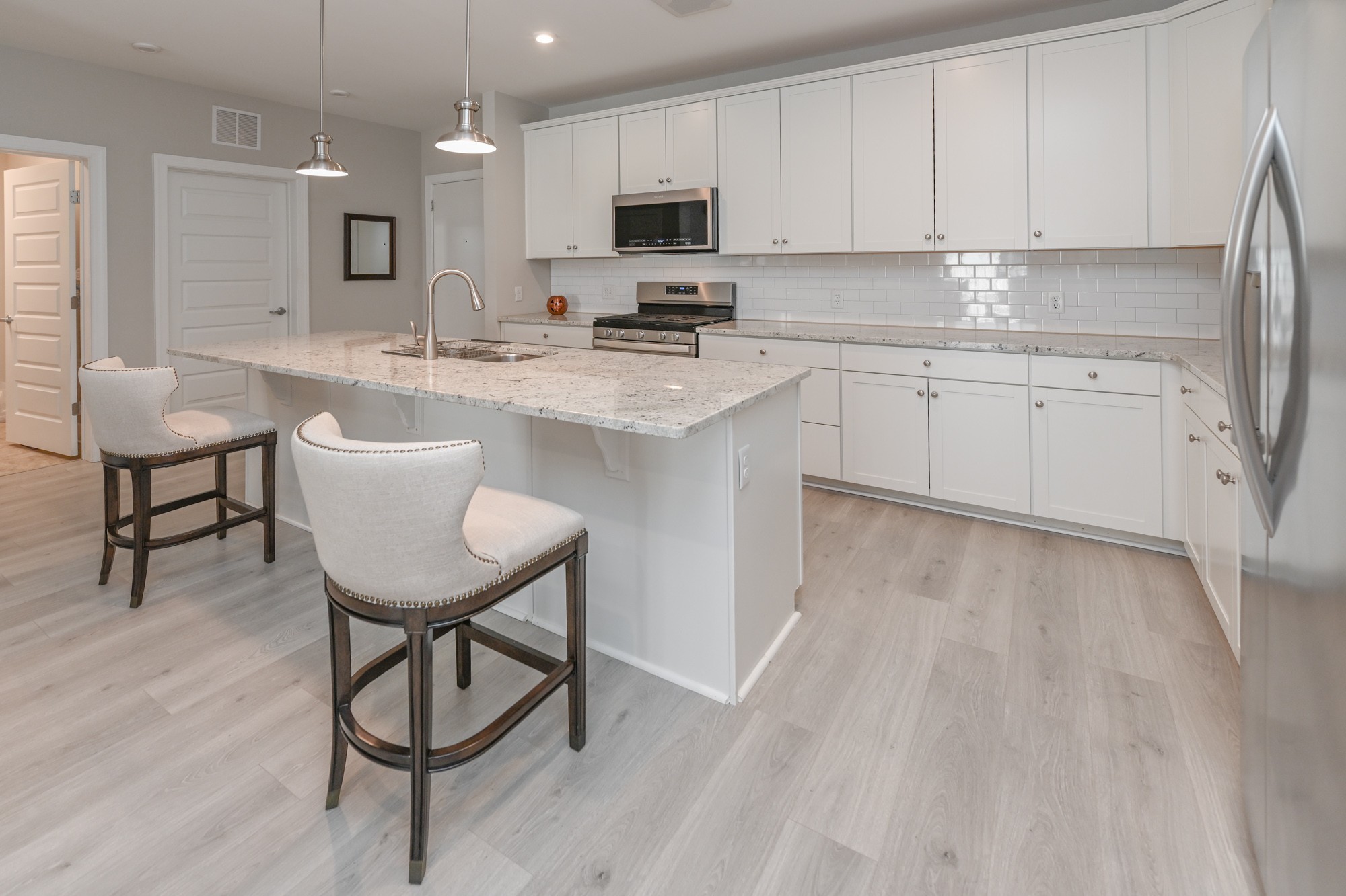 a kitchen with a sink cabinets and wooden floor