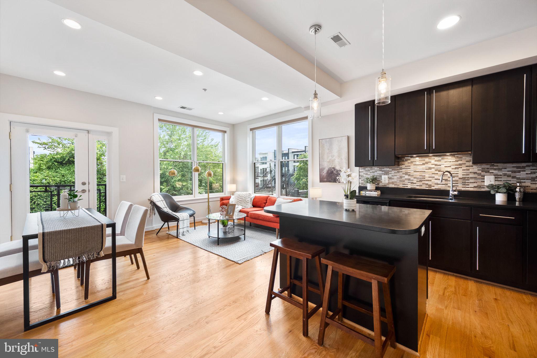 a kitchen with a table chairs stove and cabinets