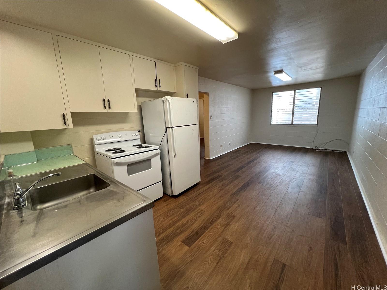 a kitchen with a refrigerator and a stove top oven