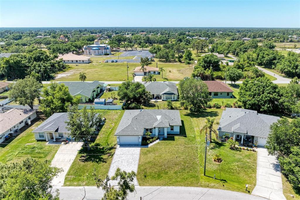 an aerial view of residential houses with outdoor space and swimming pool