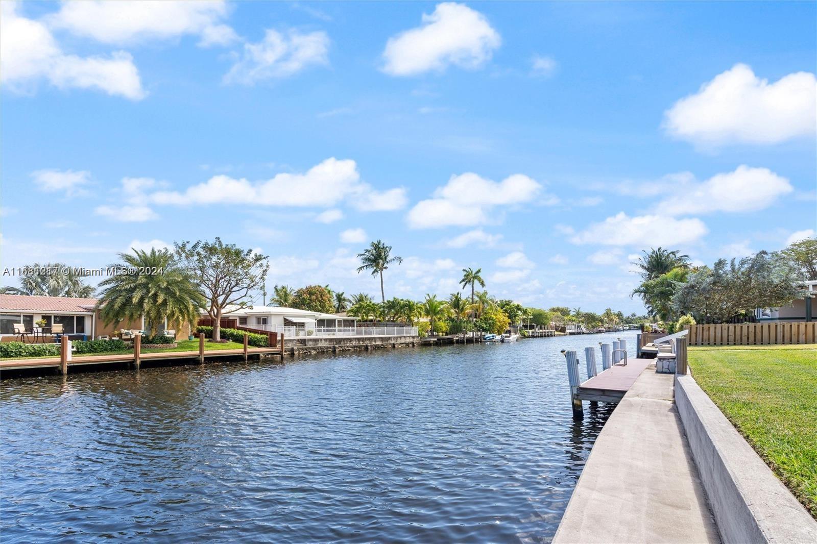 a view of a lake with houses in the back