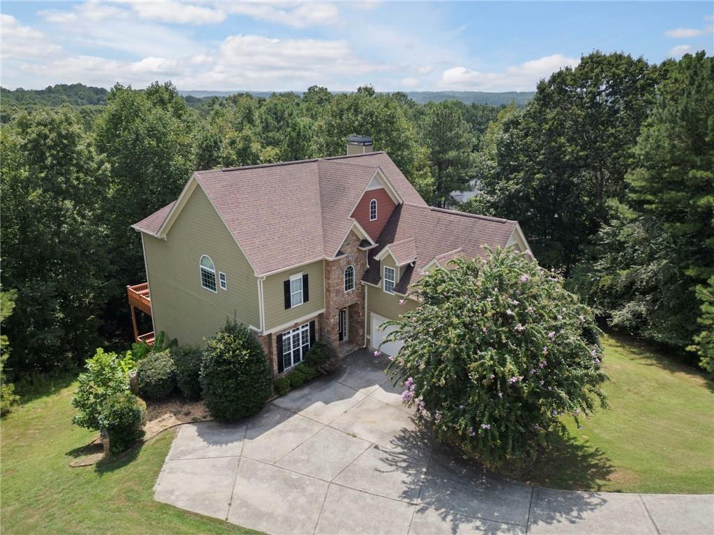 a aerial view of a house with a yard and potted plants