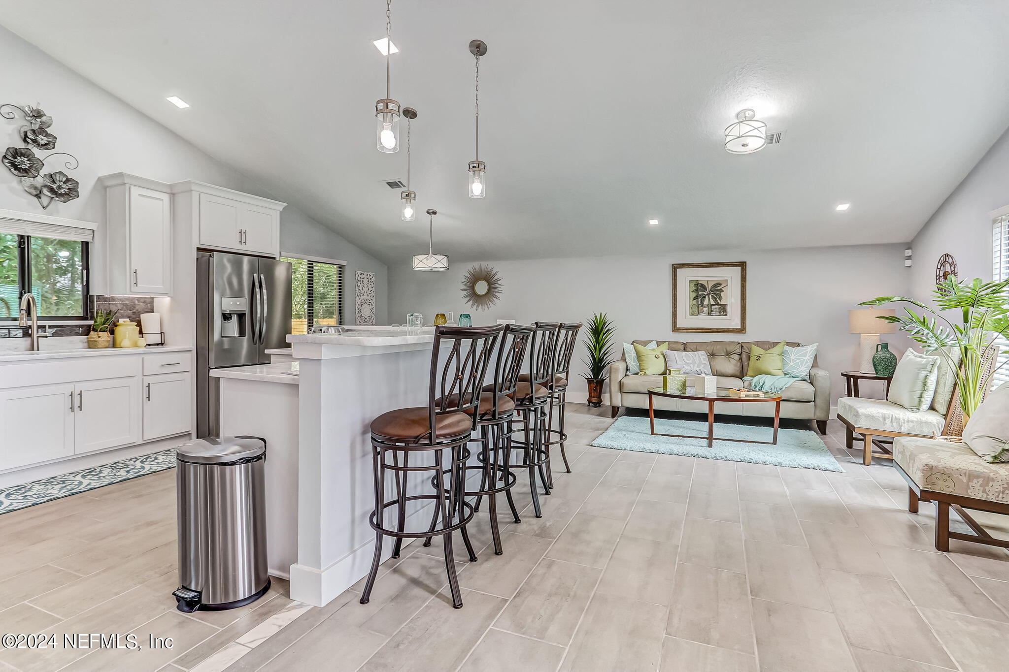 a living room with furniture and kitchen view