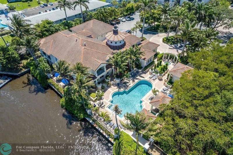 an aerial view of a house with a yard and garden