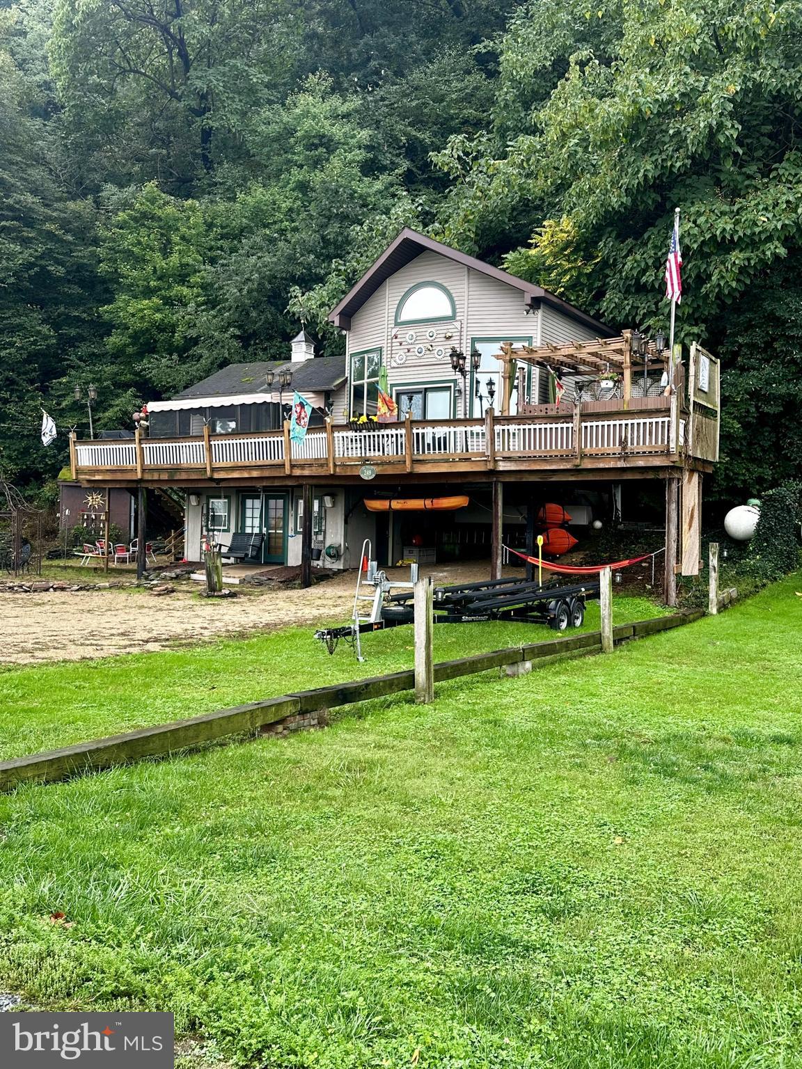 a view of a house with a yard deck and sitting area