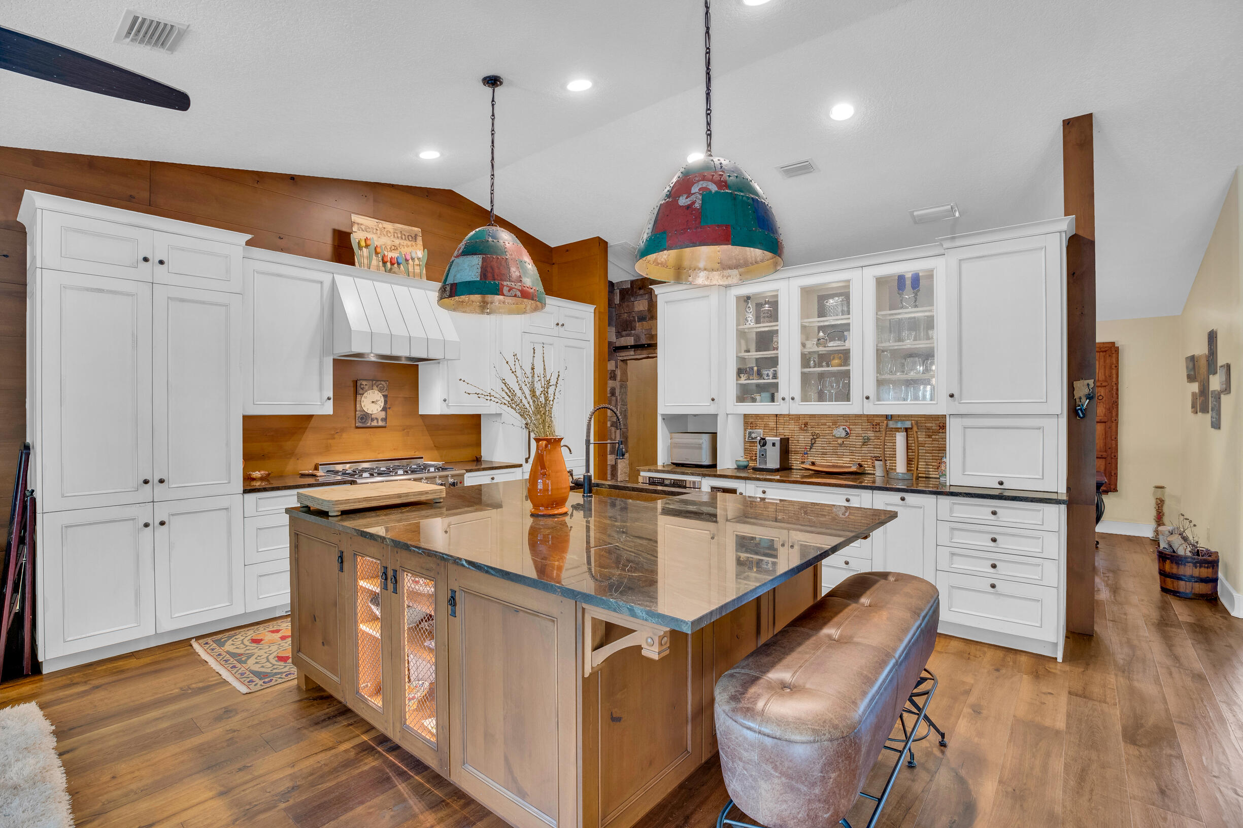 a kitchen with stainless steel appliances granite countertop a stove a sink and a refrigerator