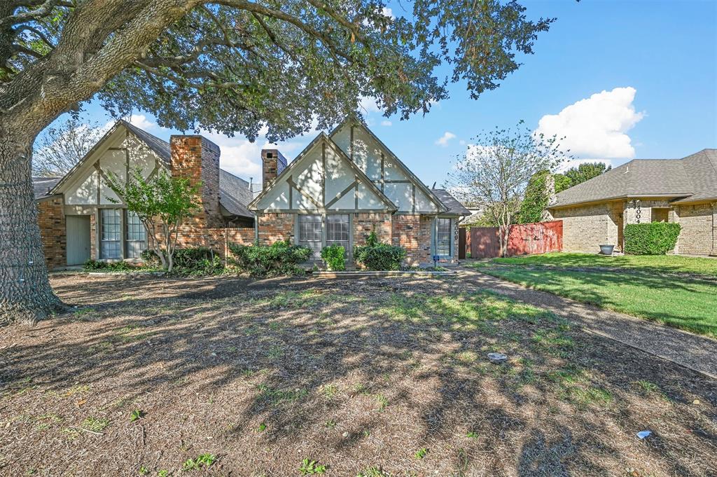 a house that has a tree in front of it