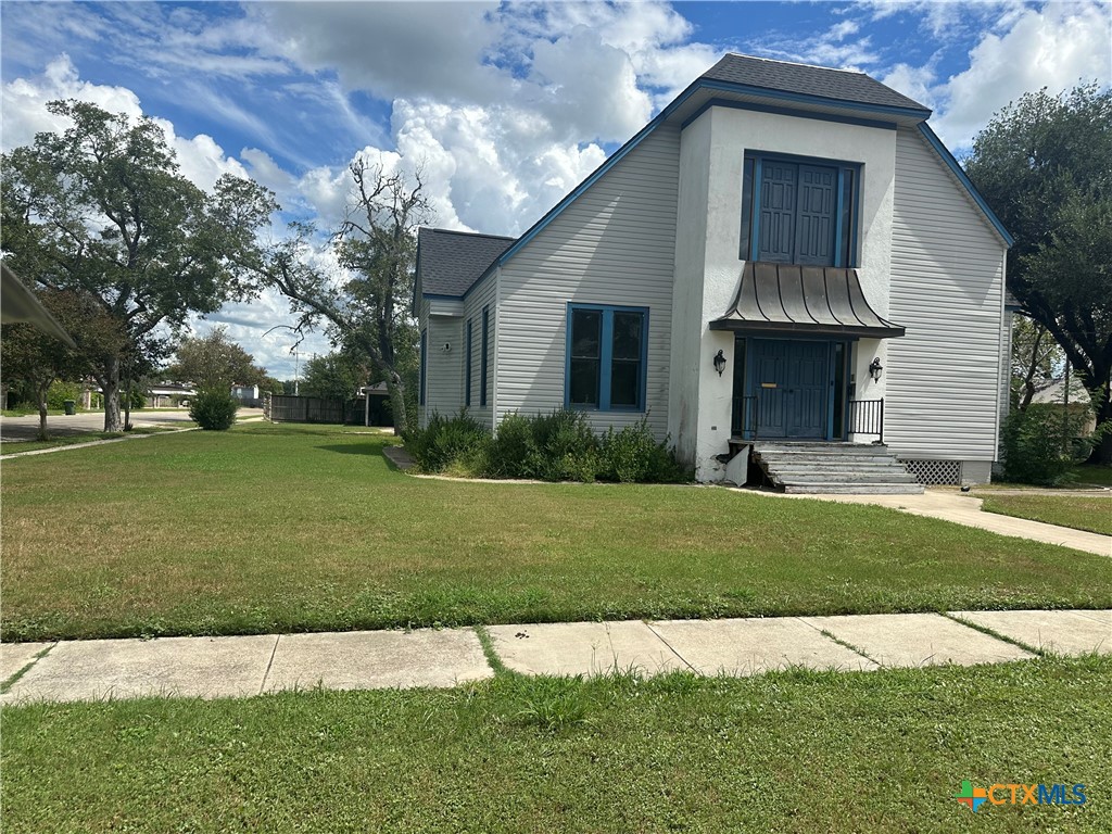 a front view of a house with a garden