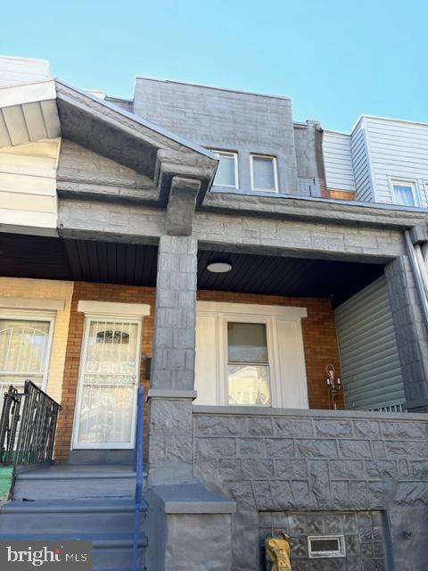 a front view of a house with large windows