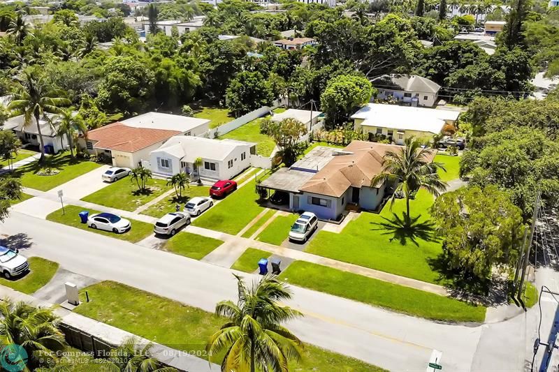 an aerial view of a house with a swimming pool yard and outdoor seating