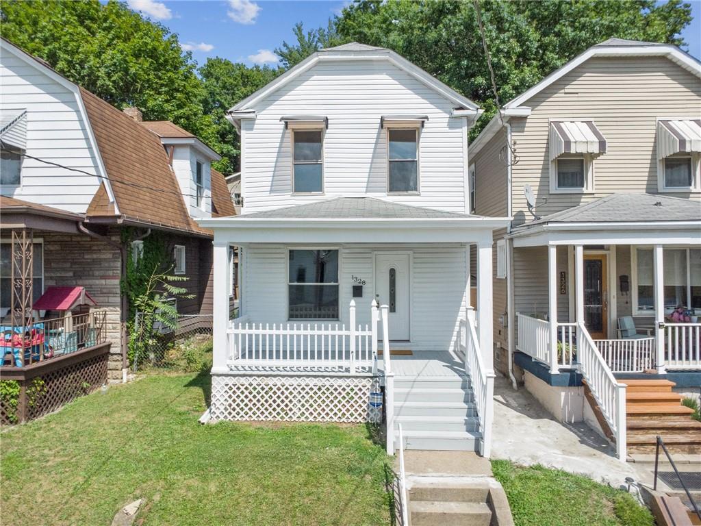 a front view of a house with a yard