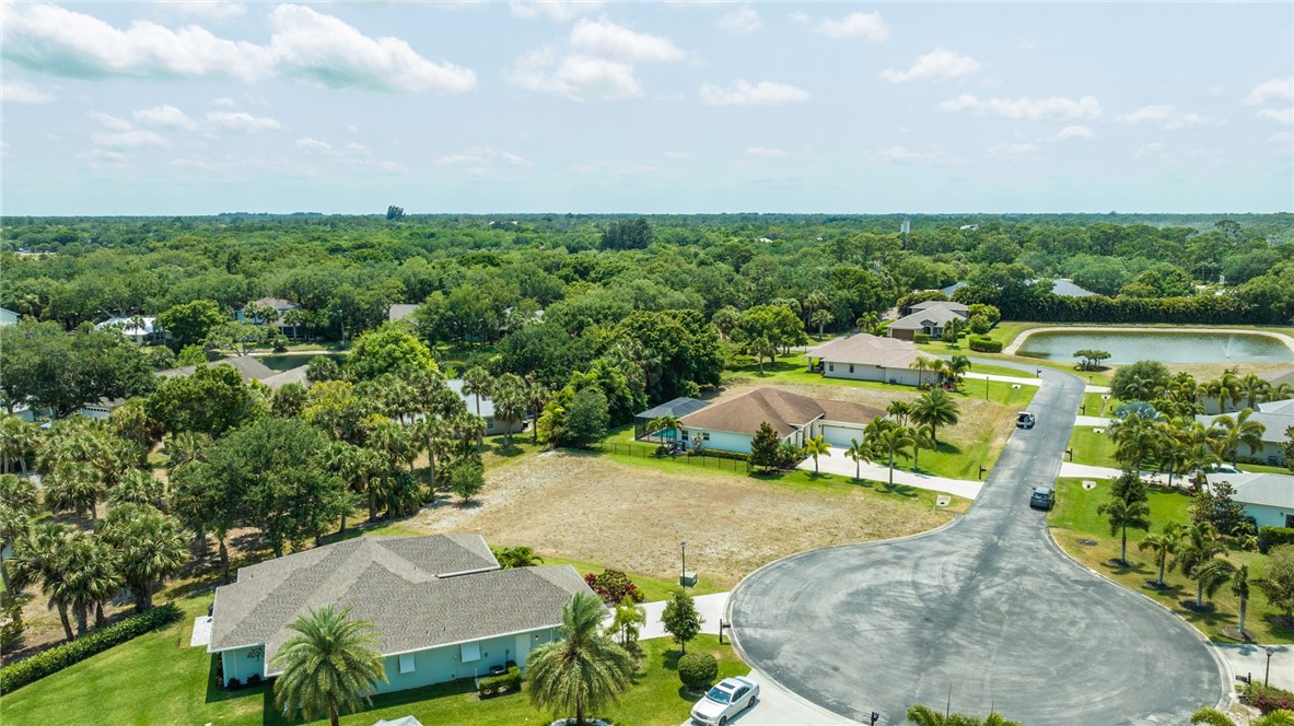 an aerial view of a house with yard