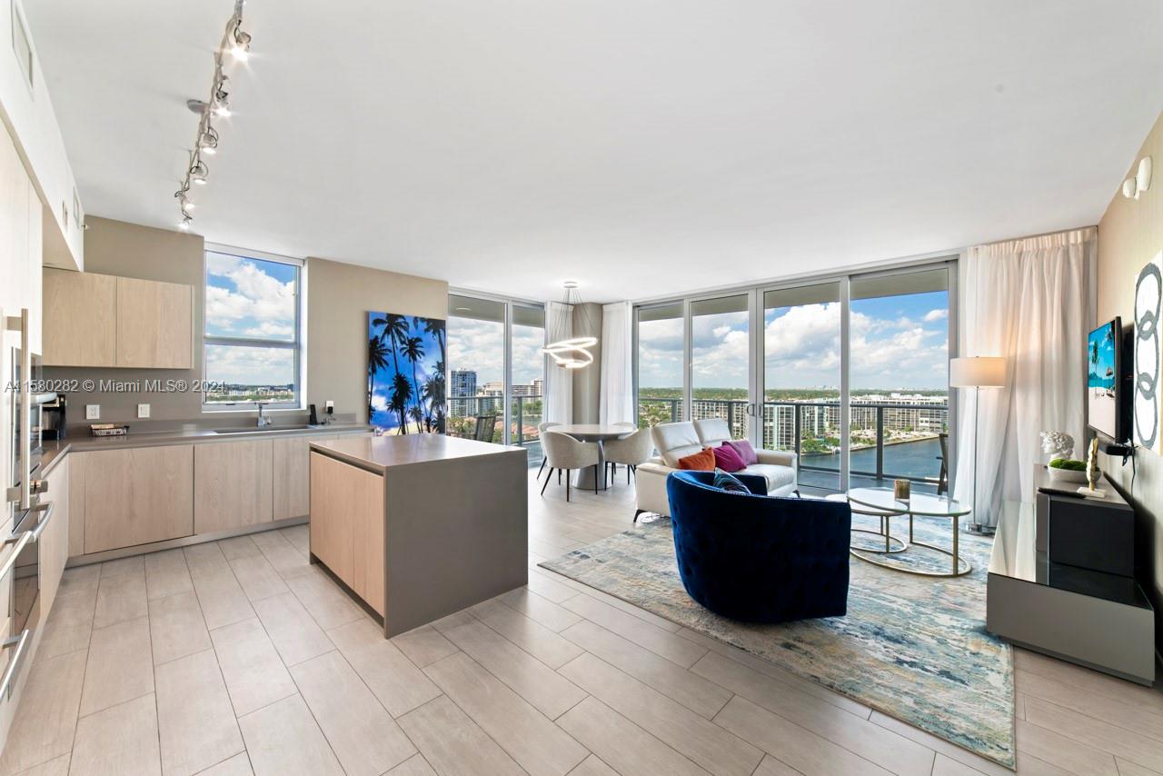 a large living room with kitchen island furniture and a kitchen view